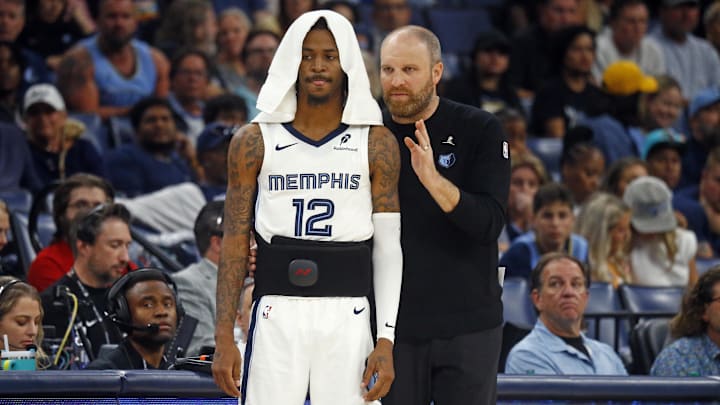 Memphis Grizzlies head coach Taylor Jenkins (right) talks with guard Ja Morant (12) as he waits to check into the game during the second half against the Brooklyn Nets at FedExForum. 