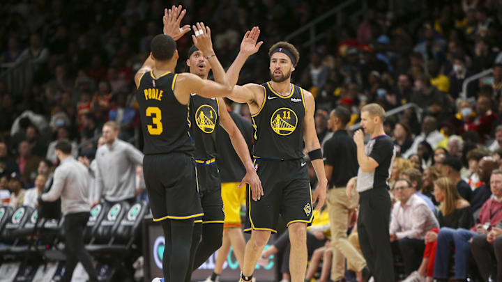 Mar 25, 2022; Atlanta, Georgia, USA; Golden State Warriors guard Klay Thompson (11) celebrates with guard Jordan Poole (3) against the Atlanta Hawks in the second half at State Farm Arena. 