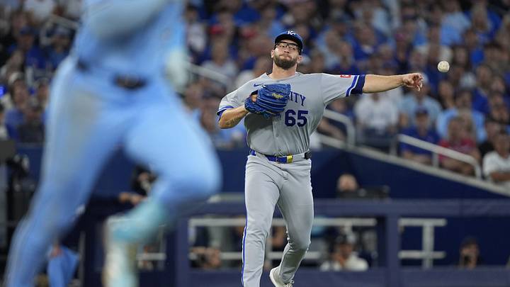 Aug 27, 2026; Toronto, Ontario, CAN;  Kansas City Royals pitcher Noah Cameron (65) throws to first base to force out Toronto Blue Jays second base Charles McAdoo (26) during the third inning at Rogers Centre.  Mandatory Credit: John E. Sokolowski-Imagn Images