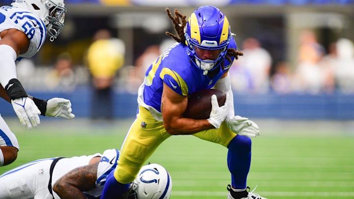 Sep 28, 2025; Inglewood, California, USA; Los Angeles Rams wide receiver Jordan Whittington (88) is brought down by Indianapolis Colts cornerback Xavien Howard (4) during the first half at SoFi Stadium. 