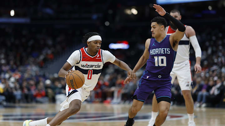 Dec 19, 2024; Washington, District of Columbia, USA; Washington Wizards guard Bilal Coulibaly (0) drives to the basket as Charlotte Hornets guard Josh Green (10) defends in the third quarter at Capital One Arena. Mandatory Credit: Geoff Burke-Imagn Images