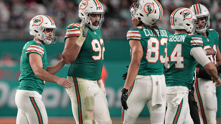 Miami Dolphins place kicker Jason Sanders, left, is congratulated by teammates after making a field