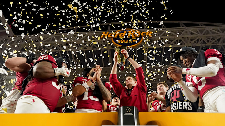Indiana Hoosiers head coach Curt Cignetti hoists the championship trophy Monday, Jan. 19, 2026, after defeating the Miami (FL) Hurricanes in the College Football Playoff National Championship college football game at Hard Rock Stadium in Miami Gardens.