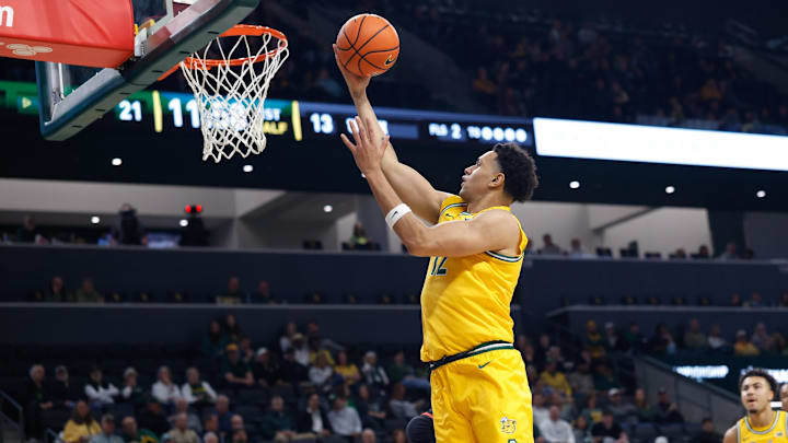 Mar 7, 2026; Waco, Texas, USA; Baylor Bears guard Michael Rataj (12) scores a layup against the Utah Utes during the first half at Paul and Alejandra Foster Pavilion. Mandatory Credit: Chris Jones-Imagn Images Mar 7, 2026; Waco, Texas, USA; Baylor Bears guard Michael Rataj (12) scores a layup against the Utah Utes during the first half at Paul and Alejandra Foster Pavilion. Mandatory Credit: Chris Jones-Imagn Images