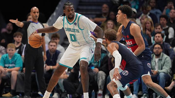 Charlotte Hornets center Naz Reid (0) works the ball against Washington Wizards forward Kyshawn George Charlotte Hornets center Naz Reid (0) works the ball against Washington Wizards forward Kyshawn George