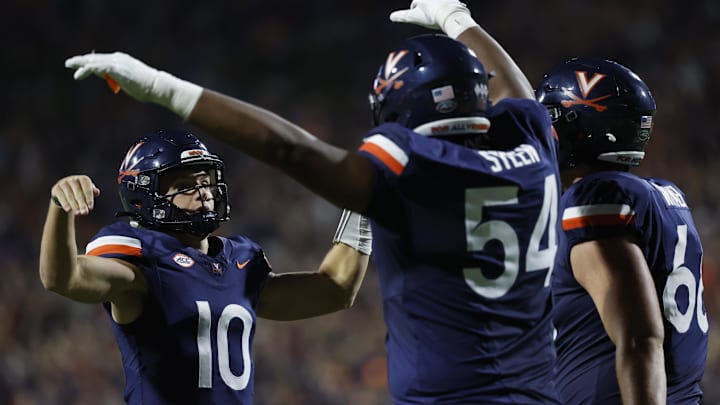 Virginia Cavaliers quarterback Anthony Colandrea (10) celebrates with Cavaliers offensive lineman Blake Steen (54) after scoring a touchdown against the Maryland Terrapins during the first half at Scott Stadium.