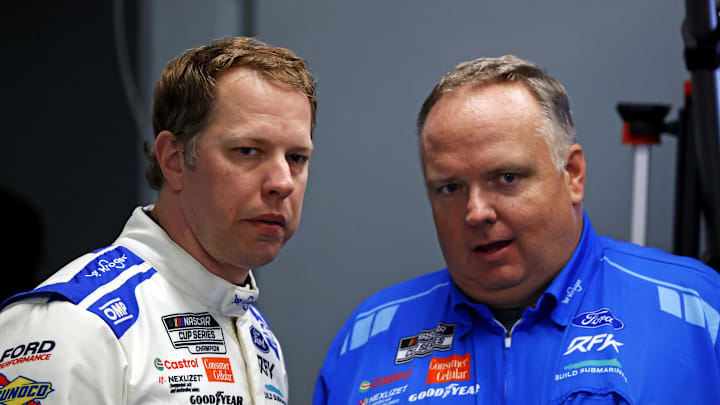 NASCAR Cup Series driver Brad Keselowski (6) talks to his crew chief Jeremy Bullins during practice for the Daytona 500 at Daytona International Speedway.
