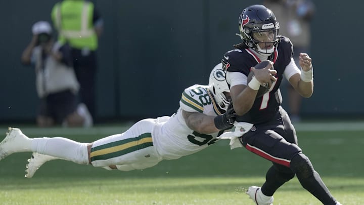Oct 20, 2024; Green Bay, Wisconsin, USA; Green Bay Packers linebacker Isaiah McDuffie (58) tackles Houston Texans quarterback C.J. Stroud (7) during the fourth quarter of their game at Lambeau Field. Mandatory Credit: Mark Hoffman/Milwaukee Journal Sentinel via the USA TODAY NETWORK-Wisconsin-Imagn Images