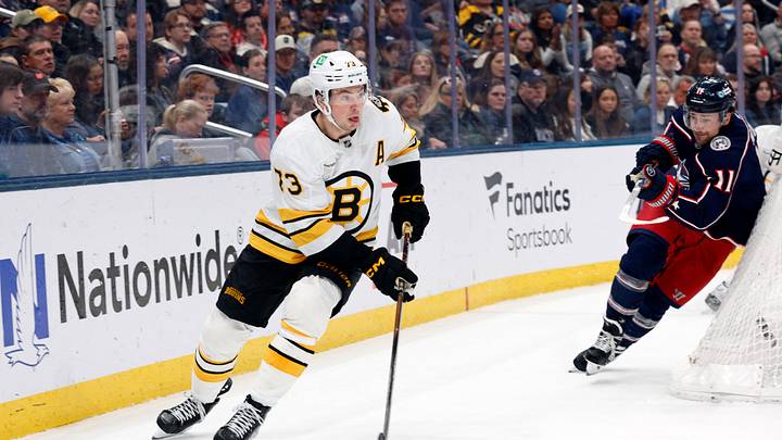 Mar 29, 2026; Columbus, Ohio, USA; Boston Bruins defenseman Charlie McAvoy (73) looks to pass as Columbus Blue Jackets left wing Miles Wood (11) trails the play during the second period at Nationwide Arena. Mandatory Credit: Russell LaBounty-Imagn Images