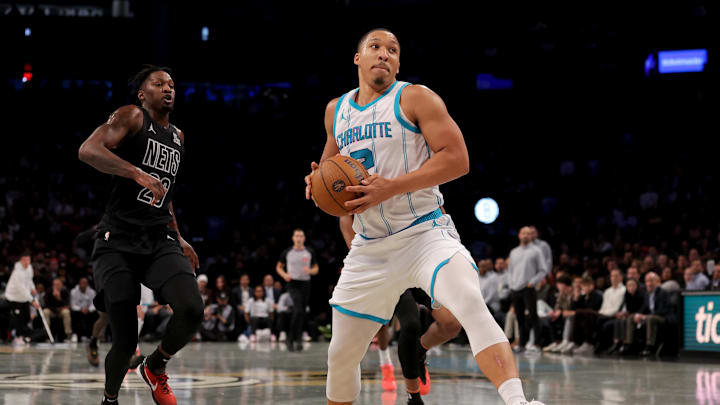Nov 19, 2024; Brooklyn, New York, USA; Charlotte Hornets forward Grant Williams (2) drives to the basket against Brooklyn Nets forward Dorian Finney-Smith (28) during the second quarter at Barclays Center. Mandatory Credit: Brad Penner-Imagn Images