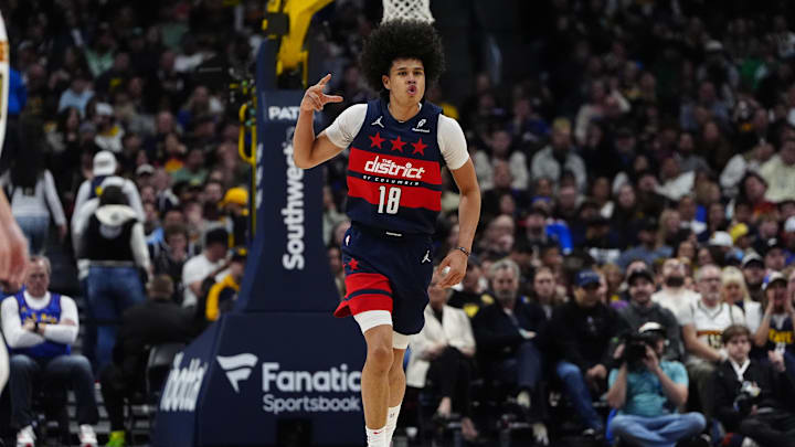 Mar 15, 2025; Denver, Colorado, USA; Washington Wizards forward Kyshawn George (18) reacts to a three-point basket in the third quarter against the Denver Nuggets at Ball Arena. Mandatory Credit: Ron Chenoy-Imagn Images