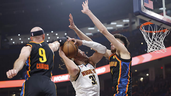 May 7, 2025; Oklahoma City, Oklahoma, USA; Oklahoma City Thunder guard Alex Caruso (9) and forward Chet Holmgren (7) defend a shot by Denver Nuggets forward Aaron Gordon (32) in the second quarter during game two of the second round for the 2025 NBA Playoffs at Paycom Center. Mandatory Credit: Alonzo Adams-Imagn Images May 7, 2025; Oklahoma City, Oklahoma, USA; Oklahoma City Thunder guard Alex Caruso (9) and forward Chet Holmgren (7) defend a shot by Denver Nuggets forward Aaron Gordon (32) in the second quarter during game two of the second round for the 2025 NBA Playoffs at Paycom Center. Mandatory Credit: Alonzo Adams-Imagn Images