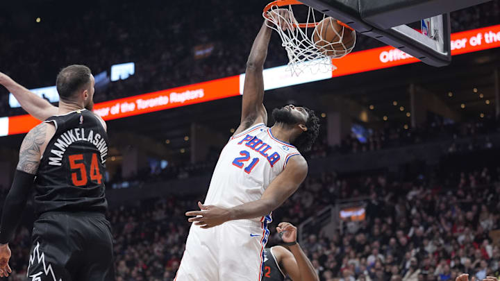 Jan 12, 2026; Toronto, Ontario, CAN; Philadelphia 76ers center Joel Embiid (21) dunks against Toronto Raptors forward Sandro Mamukelashvili (54) during the first half at Scotiabank Arena. Mandatory Credit: John E. Sokolowski-Imagn Images