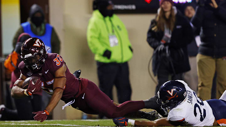 Nov 30, 2024; Virginia Tech running back Bhayshul Tuten (33) runs the ball for a touchdown during the fourth quarter against Virginia. Nov 30, 2024; Virginia Tech running back Bhayshul Tuten (33) runs the ball for a touchdown during the fourth quarter against Virginia.