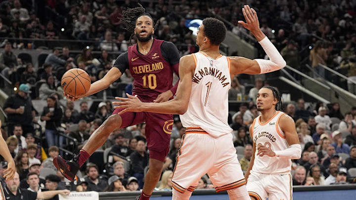Feb 3, 2024; San Antonio, Texas, USA; Cleveland Cavaliers guard Darius Garland (10) passes the ball around San Antonio Spurs forward Victor Wembanyama (1) during the second half at Frost Bank Center. Mandatory Credit: Scott Wachter-Imagn Images