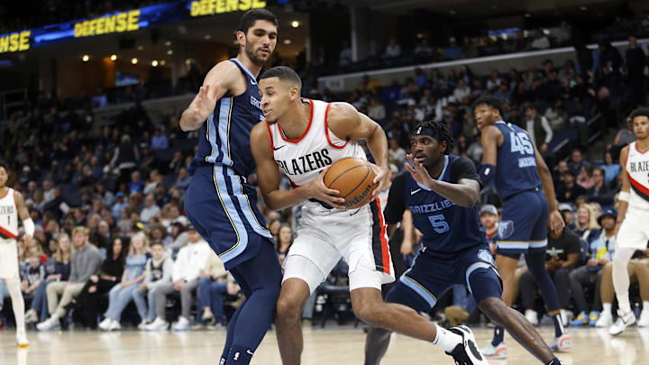 Mar 1, 2024; Memphis, Tennessee, USA; Portland Trail Blazers forward Kris Murray (8) drives to the basket as Memphis Grizzlies forward-center Santi Aldama (7) and Memphis Grizzlies guard Vince Williams Jr. (5) defend during the first half at FedExForum. Mandatory Credit: Petre Thomas-Imagn Images