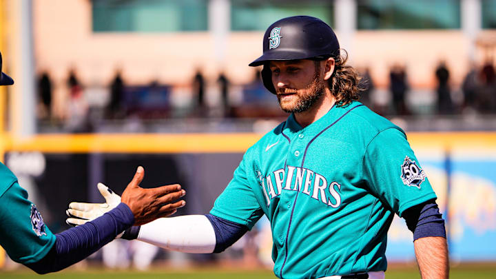 Feb 24, 2026; Peoria, Arizona, USA;  Seattle Mariners second baseman Brendan Donovan (33) gets on base during the first inning in Peoria, Arizona. Mandatory Credit: Arianna Grainey-Imagn Images