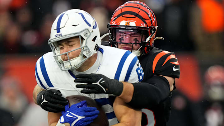 Cincinnati Bengals linebacker Logan Wilson (55) tackles Indianapolis Colts tight end Will Mallory (86) in the fourth quarter during a Week 14 NFL game between the Indianapolis Colts and the Cincinnati Bengals, Sunday, Dec. 10, 2023, at Paycor Stadium in Cincinnati.