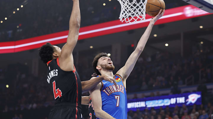 Feb 7, 2025; Oklahoma City, Oklahoma, USA; Oklahoma City Thunder forward Chet Holmgren (7) shoots beside Toronto Raptors forward Scottie Barnes (4) during the first quarter at Paycom Center. Mandatory Credit: Alonzo Adams-Imagn Images