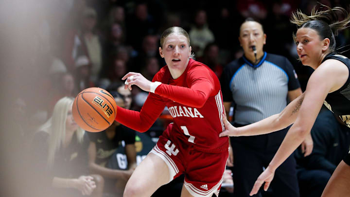 Indiana Hoosiers guard Lexus Bargesser (1) drives past Purdue Boilermakers guard Ella Collier (13) Sunday, March 2, 2025, during the NCAA women’s basketball game at Mackey Arena in West Lafayette, Ind.