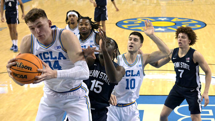 Feb 8, 2025; Los Angeles, California, USA;  UCLA Bruins forward Tyler Bilodeau (34) grabs a rebound in front of Penn State Nittany Lions forward Kachi Nzeh (15) in the first half at Pauley Pavilion presented by Wescom. Mandatory Credit: Jayne Kamin-Oncea-Imagn Images