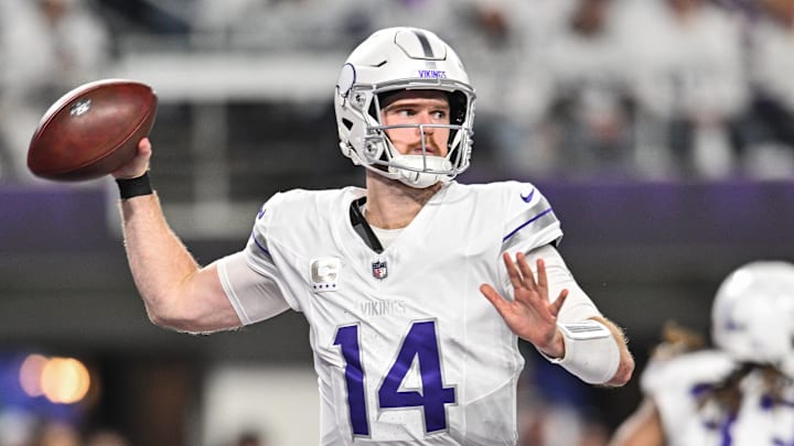 Dec 16, 2024; Minneapolis, Minnesota, USA; Minnesota Vikings quarterback Sam Darnold (14) throws a pass against the Chicago Bears during the third quarter at U.S. Bank Stadium.