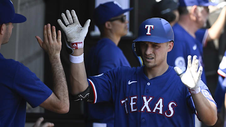 Aug 29, 2024; Chicago, Illinois, USA;  Texas Rangers shortstop Corey Seager (5) celebrates in the dugout after he hits a solo home run against the Chicago White Sox during the fourth inning at Guaranteed Rate Field. 