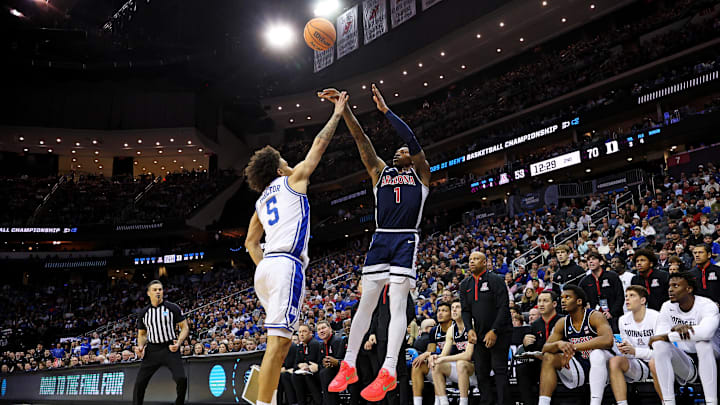 Mar 27, 2025; Newark, NJ, USA; Arizona Wildcats guard Caleb Love (1) shoots the ball against Duke Blue Devils guard Tyrese Proctor (5) during the second half during an East Regional semifinal of the 2025 NCAA tournament at Prudential Center. Mandatory Credit: Vincent Carchietta-Imagn Images