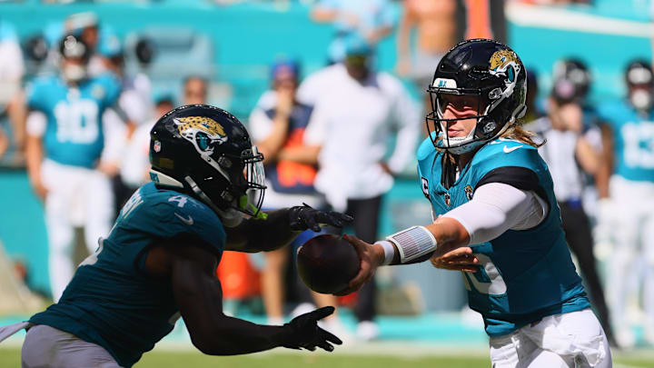 Sep 8, 2024; Miami Gardens, Florida, USA; Jacksonville Jaguars running back Tank Bigsby (4) takes a handoff from quarterback Trevor Lawrence (16) during the fourth quarter at Hard Rock Stadium. 