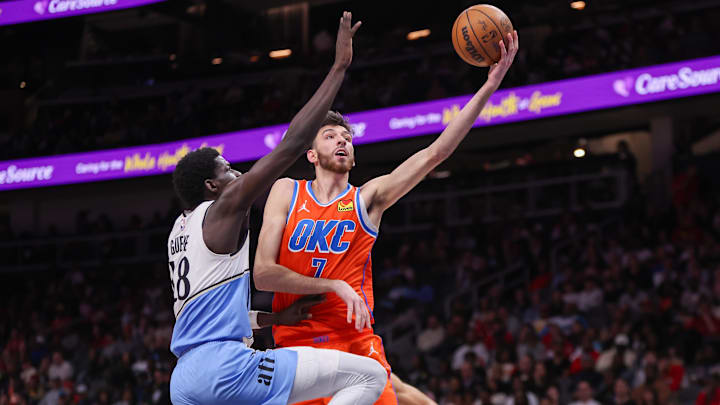 Feb 28, 2025; Atlanta, Georgia, USA; Oklahoma City Thunder forward Chet Holmgren (7) shoots past Atlanta Hawks forward Mouhamed Gueye (18) in the second quarter at State Farm Arena. Mandatory Credit: Brett Davis-Imagn Images

