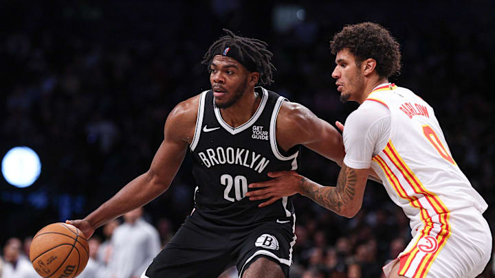 Mar 16, 2025; Brooklyn, New York, USA; Brooklyn Nets center Day'Ron Sharpe (20) is defended by Atlanta Hawks forward Dominick Barlow (0) during the second half at Barclays Center. Mandatory Credit: Vincent Carchietta-Imagn Images