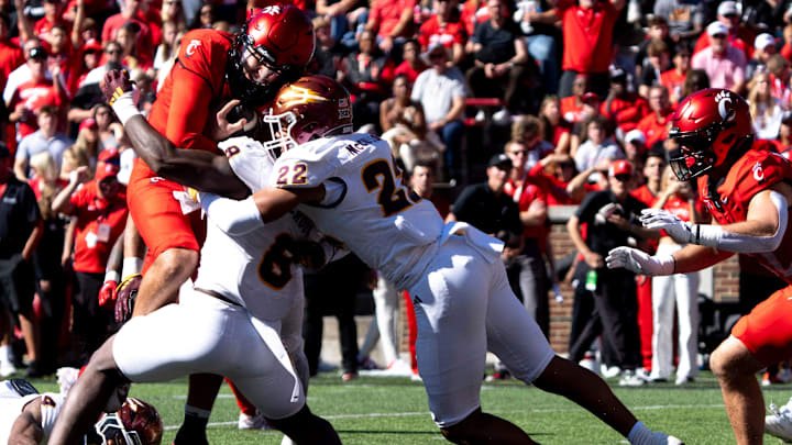 Cincinnati Bearcats quarterback Brendan Sorsby (2) scores a touchdown Arizona State Sun Devils linebacker Jordan Crook (8) and Arizona State Sun Devils linebacker Caleb McCullough (22) attempt to stop him in the second quarter of the College Football game at Nippert Stadium in Cincinnati on Saturday, Oct. 19, 2024.