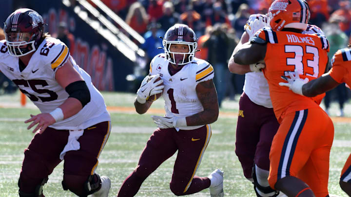 Nov 2, 2024; Champaign, Illinois, USA;  Minnesota Golden Gophers running back Darius Taylor (1) runs the through the Illinois Fighting Illini defense the during the second half at Memorial Stadium. Mandatory Credit: Ron Johnson-Imagn Images