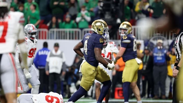 Jan 20, 2025; Atlanta, GA, USA; Notre Dame Fighting Irish running back Jeremiyah Love (4) scores a two-point conversion against the Ohio State Buckeyes during the second half the CFP National Championship college football game at Mercedes-Benz Stadium. Mandatory Credit: Mark J. Rebilas-Imagn Images