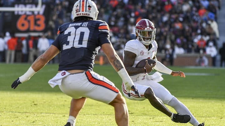 Nov 25, 2023; Auburn, Alabama, USA;  Alabama Crimson Tide quarterback Jalen Milroe (4) cuts back as