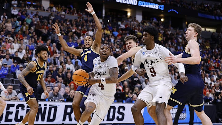 Mar 22, 2025; Denver, CO, USA; Texas A&M Aggies guard Wade Taylor IV (4) dribbles the ball past Michigan Wolverines guard Nimari Burnett (4) during the second half in the second round of the NCAA Tournament  at Ball Arena. Mandatory Credit: Isaiah J. Downing-Imagn Images