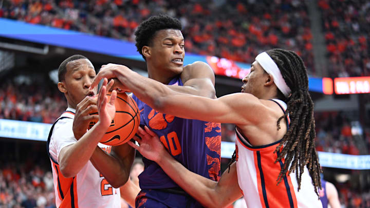 Feb 10, 2024; Syracuse, New York, USA; Clemson Tigers forward RJ Godfrey (10) wrestles a rebound from Syracuse Orange guard Quadir Copeland (left) and forward Maliq Brown (right) in the second half at the JMA Wireless Dome. Mandatory Credit: Mark Konezny-Imagn Images