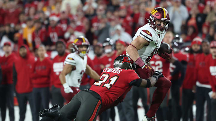 Jan 12, 2025; Tampa, Florida, USA; Washington Commanders tight end Zach Ertz (86) runs against Tampa Bay Buccaneers safety Antoine Winfield Jr. (31) during the fourth quarter of a NFC wild card playoff at Raymond James Stadium. Mandatory Credit: Kim Klement Neitzel-Imagn Images