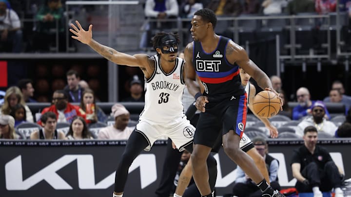 Mar 1, 2025; Detroit, Michigan, USA;  Detroit Pistons center Jalen Duren (0) dribbles against Brooklyn Nets center Nic Claxton (33) in the first half at Little Caesars Arena. Mandatory Credit: Rick Osentoski-Imagn Images