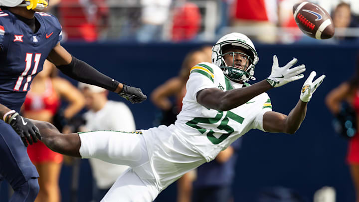 Nov 22, 2025; Tucson, Arizona, USA; Baylor Bears cornerback LeVar Thornton Jr. (25) attempts to intercept a pass against the Arizona Wildcats in the first half at Casino Del Sol Stadium. Mandatory Credit: Mark J. Rebilas-Imagn Images