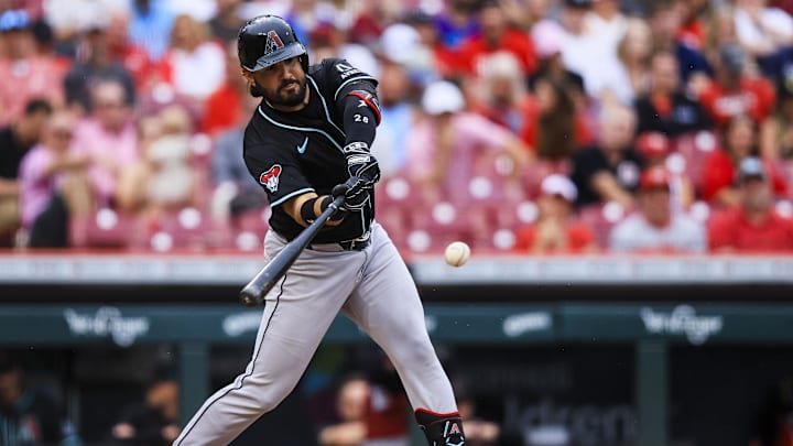 Jun 7, 2025; Cincinnati, Ohio, USA; Arizona Diamondbacks third baseman Eugenio Suarez (28) hits a single in the eighth inning against the Cincinnati Reds at Great American Ball Park.