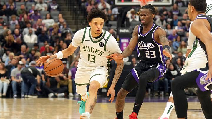 Mar 22, 2025; Sacramento, California, USA; Milwaukee Bucks guard Ryan Rollins (13) dribbles against Sacramento Kings guard Keon Ellis (23) during the first quarter at Golden 1 Center. Mandatory Credit: Darren Yamashita-Imagn Images