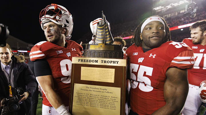 Nov 18, 2023; Madison, Wisconsin, USA;  The Wisconsin Badgers celebrate with the Freedom Trophy following the game against the Nebraska Cornhuskers at Camp Randall Stadium. Mandatory Credit: Jeff Hanisch-Imagn Images