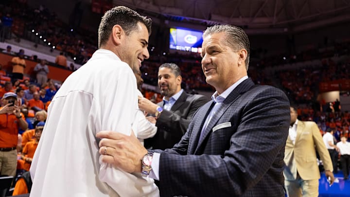 Florida Gators coach Todd Golden and Arkansas Razorbacks coach John Calipari talk before the game at Exactech Arena at the Stephen C. O'Connell Center.