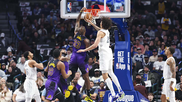 Jan 7, 2025; Dallas, Texas, USA;  Los Angeles Lakers forward LeBron James (23) dunks past Dallas Mavericks center Dereck Lively II (2) during the first quarter at American Airlines Center. Mandatory Credit: Kevin Jairaj-Imagn Images