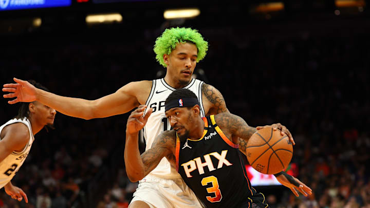 Dec 3, 2024; Phoenix, Arizona, USA; Phoenix Suns guard Bradley Beal (3) controls the ball against San Antonio Spurs forward Jeremy Sochan in the second half of an NBA Cup game at Footprint Center. Mandatory Credit: Mark J. Rebilas-Imagn Images