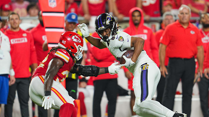 Sep 5, 2024; Kansas City, Missouri, USA; Baltimore Ravens tight end Isaiah Likely (80) runs with the ball against Kansas City Chiefs linebacker Nick Bolton (32) during the second half at GEHA Field at Arrowhead Stadium. Mandatory Credit: Jay Biggerstaff-Imagn Images