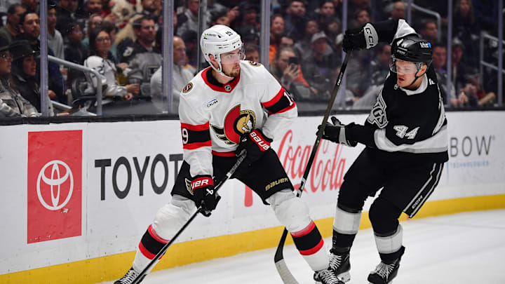 Nov 24, 2025; Los Angeles, California, USA; Los Angeles Kings defenseman Mikey Anderson (44) plays for the puck against Ottawa Senators right wing Drake Batherson (19) during the third period at Crypto.com Arena. Mandatory Credit: Gary A. Vasquez-Imagn Images