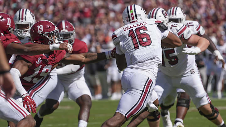 Oct 12, 2024; Tuscaloosa, Alabama, USA;  South Carolina Gamecocks wide receiver Vandrevius Jacobs (19) evades a rush by Alabama Crimson Tide linebacker Keanu Koht (19) at Bryant-Denny Stadium. Mandatory Credit: Gary Cosby Jr.-Imagn Images