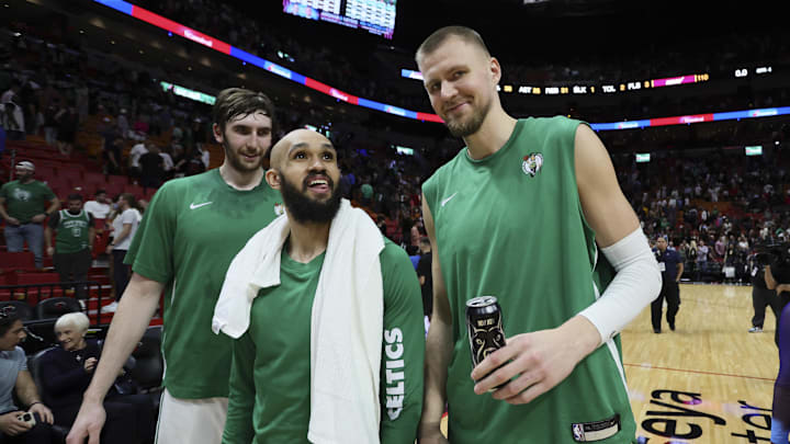 Jan 25, 2024; Miami, Florida, USA; Boston Celtics center Kristaps Porzingis (right), guard Derrick White (center) and center Luke Kornet (left) look on after the game against the Miami Heat at Kaseya Center. Mandatory Credit: Sam Navarro-Imagn Images